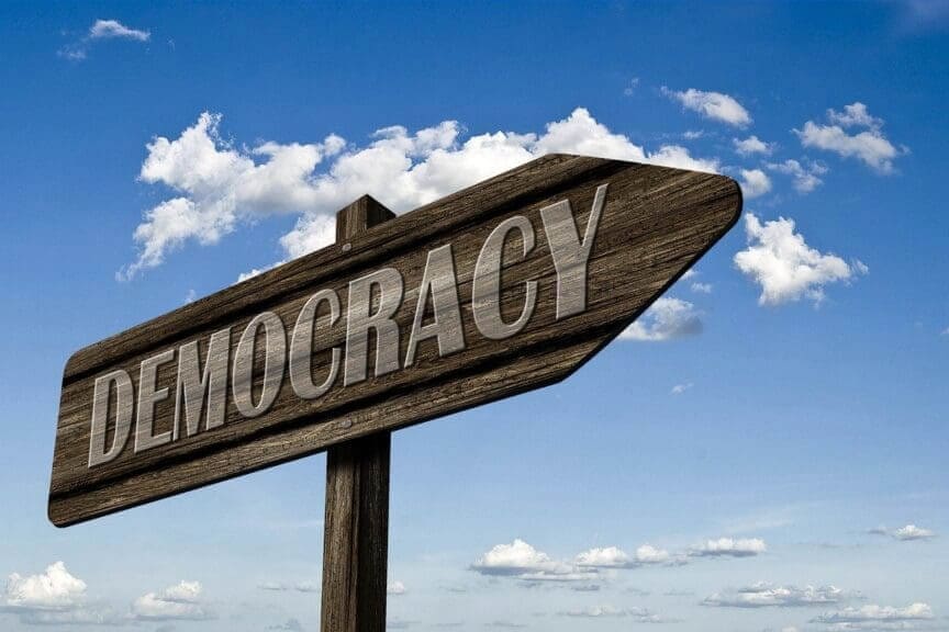 Overturn election wooden democracy sign with a blue sky in the background
