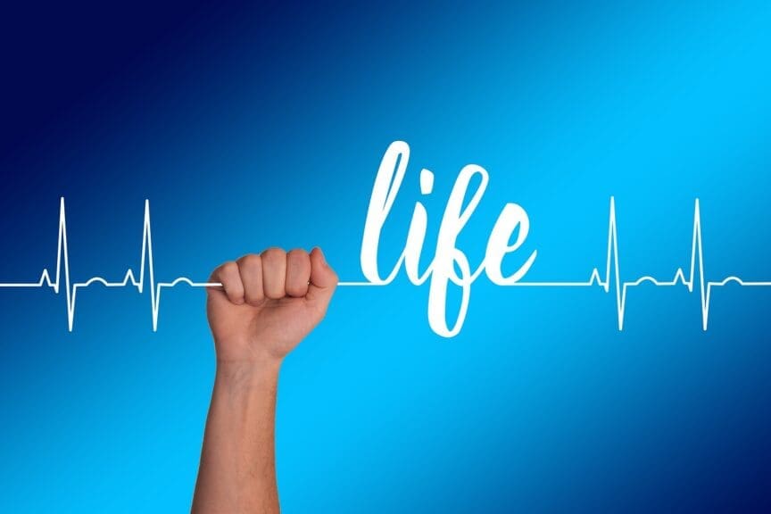 A hand holding a string with a heartbeat line