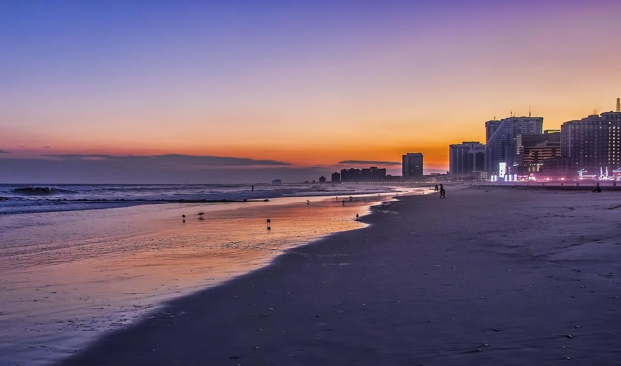 Jersey shore beach at sunset with the boardwalk shown in the background