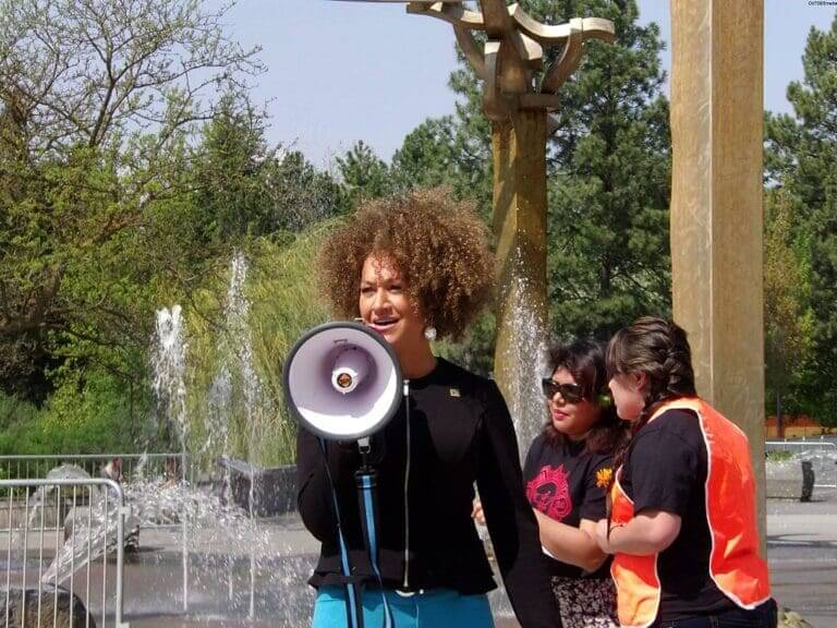 Rachel Dolezal speaks into a bullhorn at a rally as part of the NAACP.