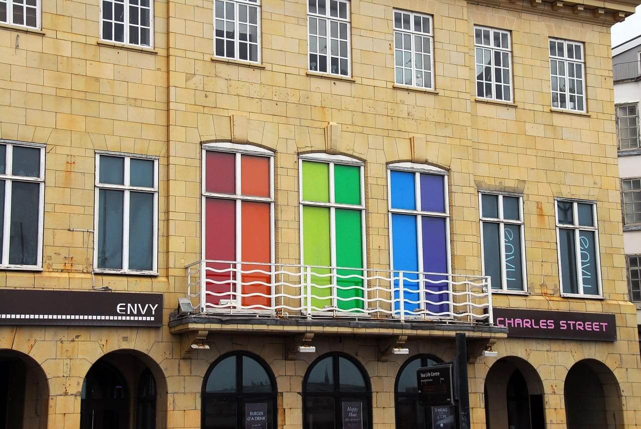 Myths about the lgbtq+ community. Rainbow colored windown in a building