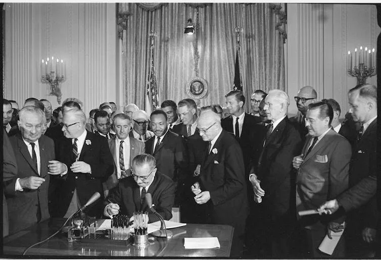 image Attack on dei. Lyndon b johnson signing civil rights bill