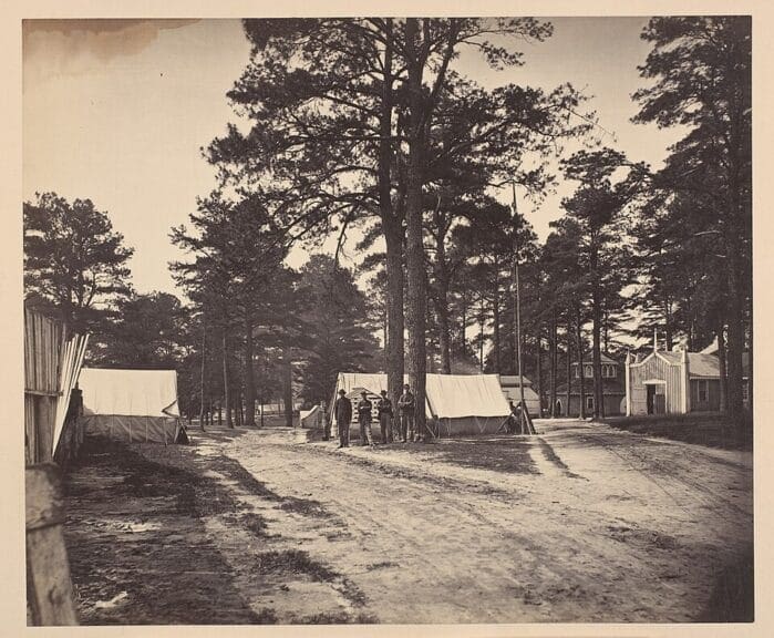 civil war The insurrection act photo taken during the civil warvshowing soldiers standing near tents.