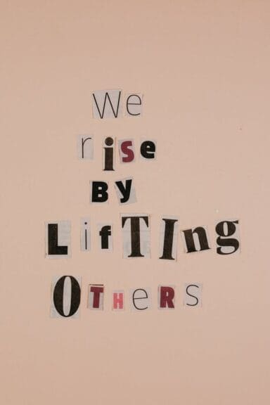 Motivational words on cutouts forming an uplifting message on a beige background.
