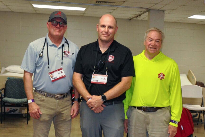 Three men who are from left: rusty lowe, wes michaels and glenn davis are the leaders of ems operations at bryant-denny stadium. Credit: olivia mcmurrey/inside climate news