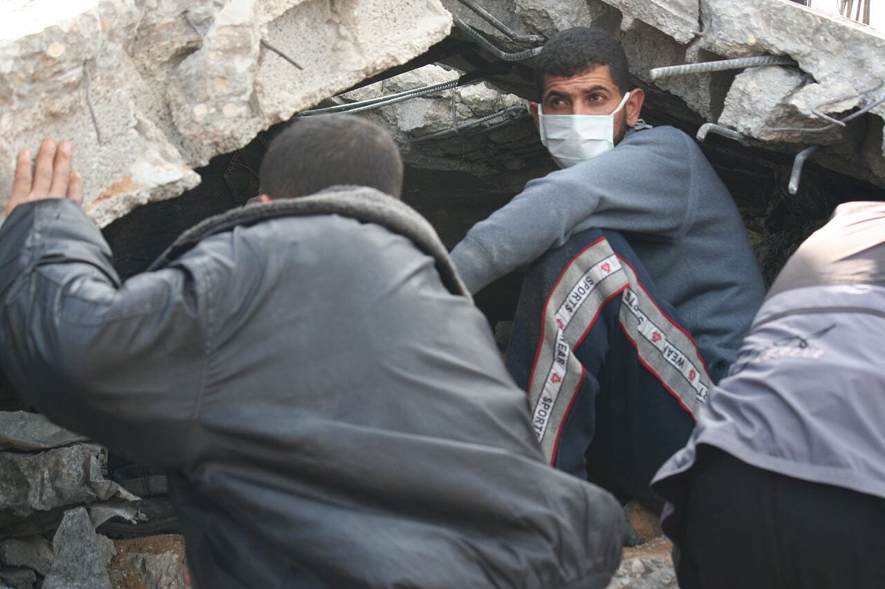 Workers dig through rubble in search of bodies in gaza