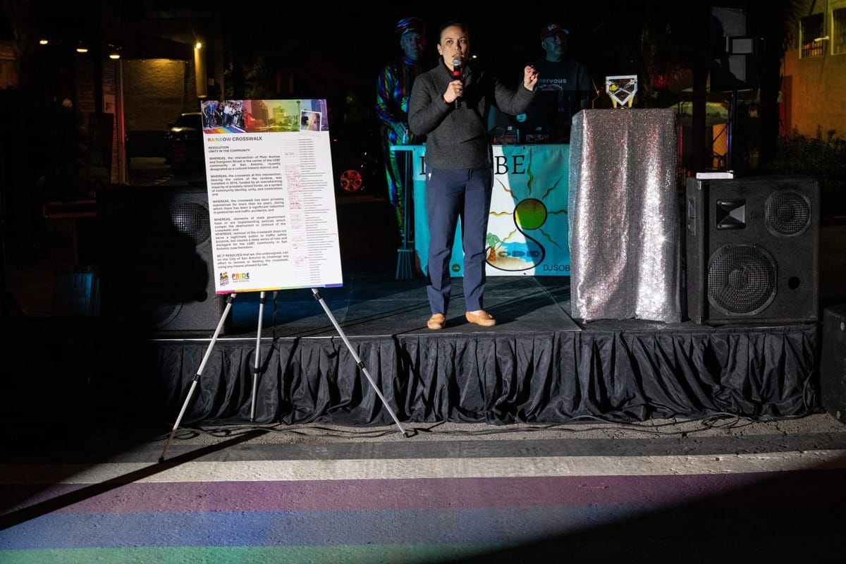 Tx mayor speaking at the site of a rainbow crosswalk.