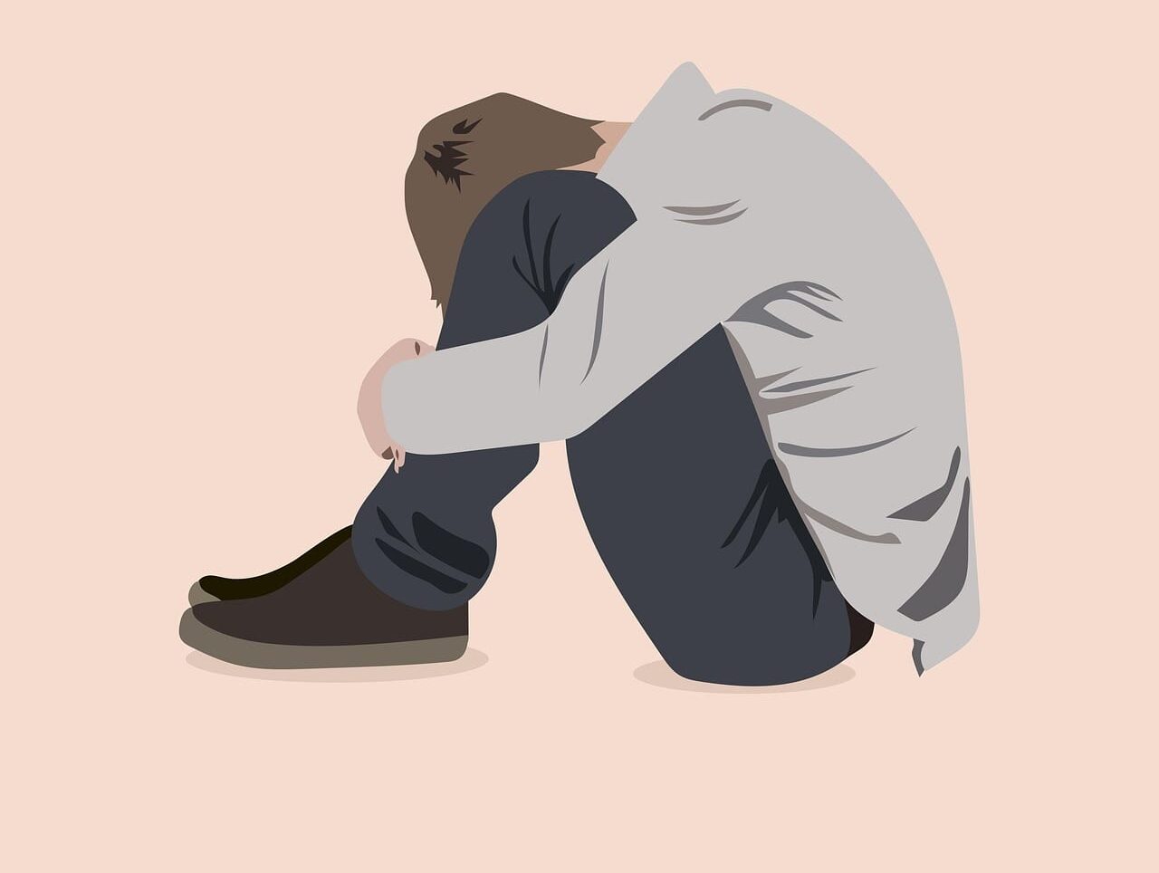 Kgbtq mental health resources. Illustration if a young man sitting on the floor with his head between his knees