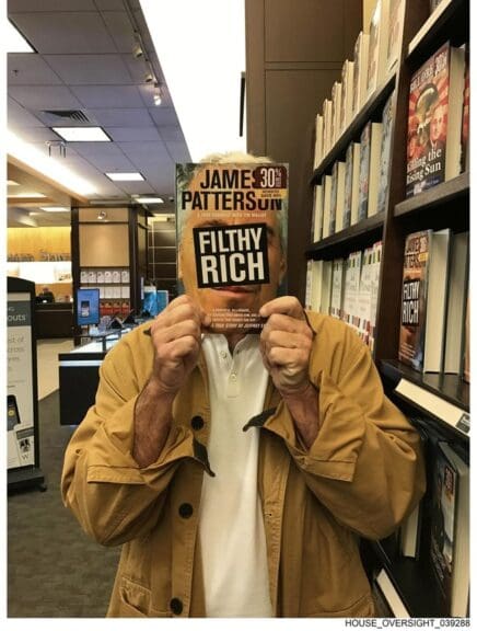 Epstein holding his book in front of his face