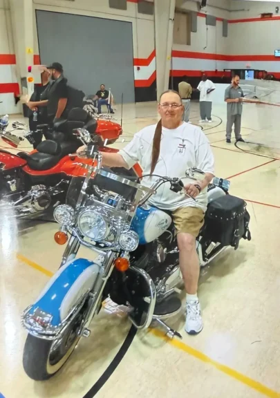 Transgender woman in prison sitting on a motorcycle