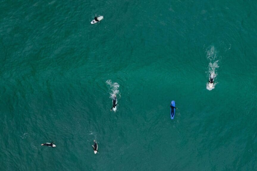 Aerial view of surfers in the ocean.