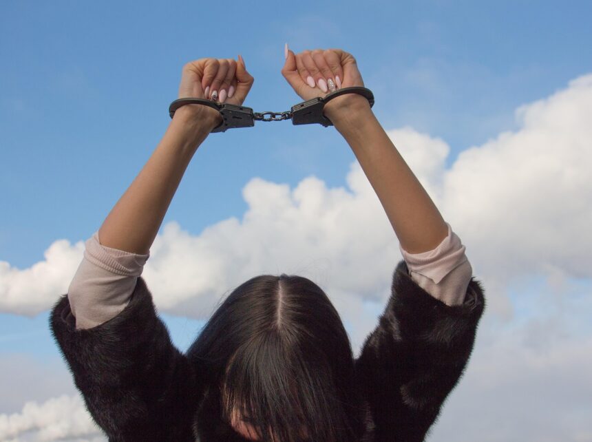 Civil rights violations woman in handcuffs. Abortion is homicide