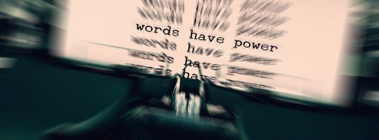 Typewriter and paper with the power of words typed on it