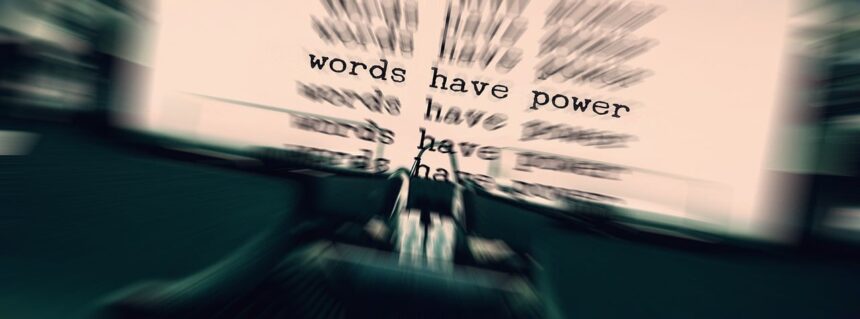 Typewriter and paper with the power of words typed on it