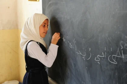 Girls school in Iran. A girl writes on a chalkboard