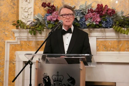 Peter Mandelson speaking at a podium