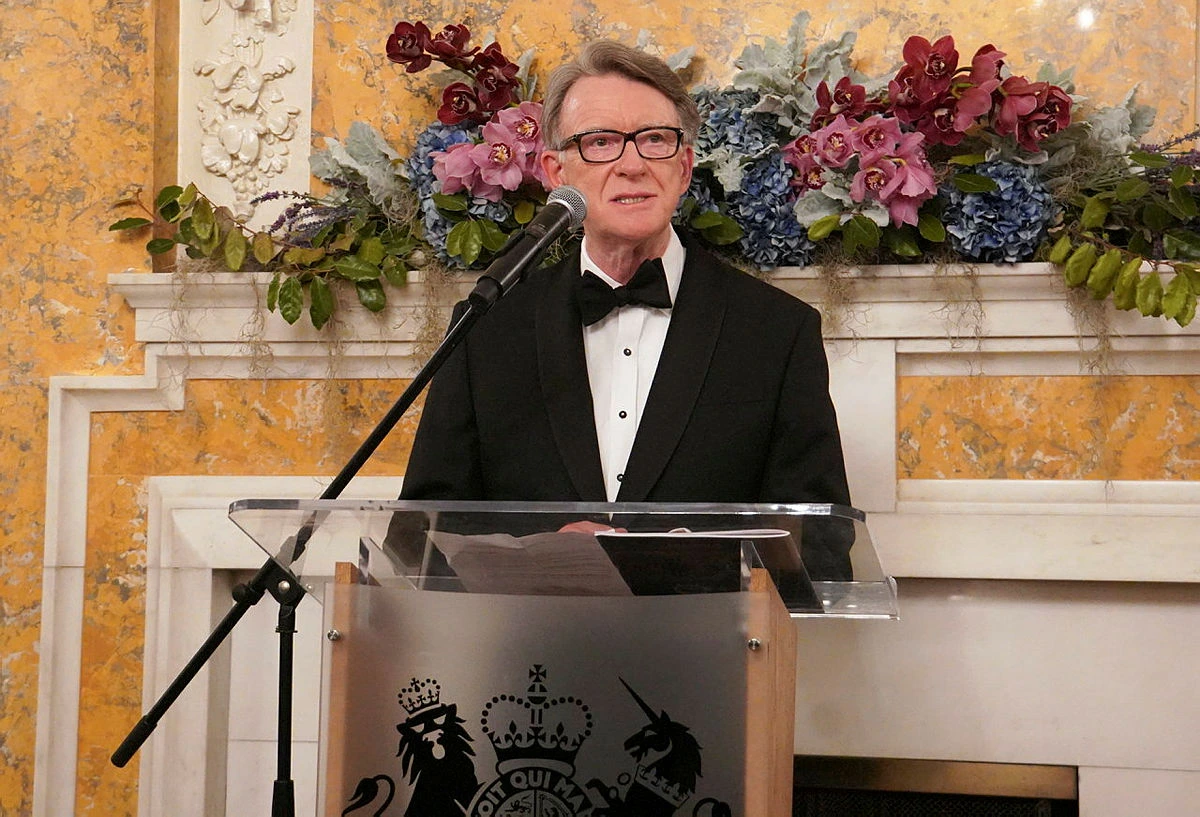 Peter mandelson speaking at a podium