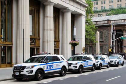 NYPD vehicles parked along the street in the city
