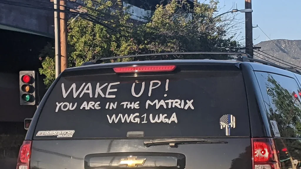 Qanon writing about deep state on rear window of an suv