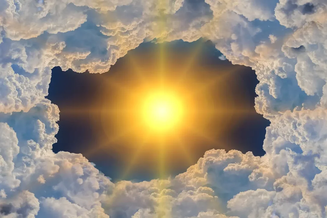 Sun shining through clouds and greenhouse gases