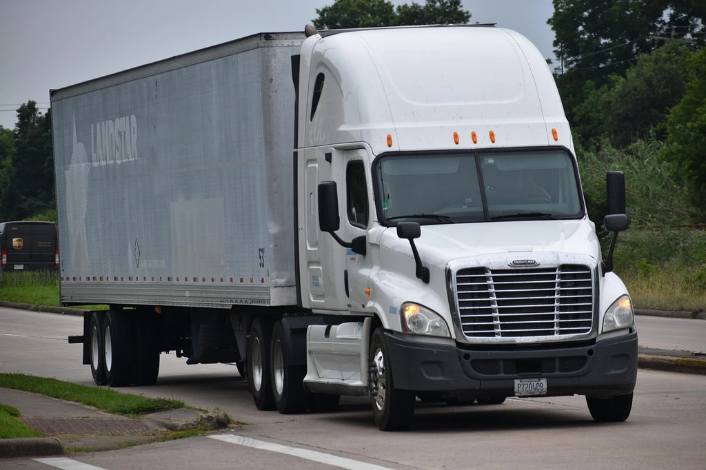 shipping tractor trailer Tractor trailer driving on a highway