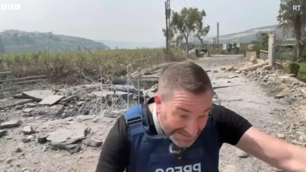 Steve sweeney ducks and covers right before an israeli bomb hit, injuring him.