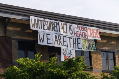 Sign hanging on the Minneapolis police department during the civil unrest following the killing of George Floyd