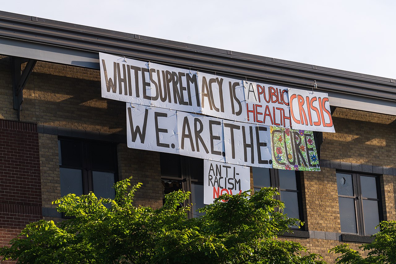 Sign hanging on the minneapolis police department during the civil unrest following the killing of george floyd