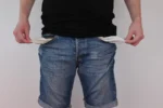 2027 budget cuts benefits to fund war. A man showing empty pockets