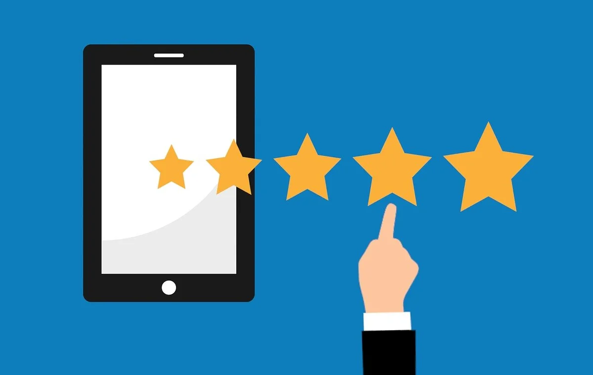 Image of a hand clicking on review stars