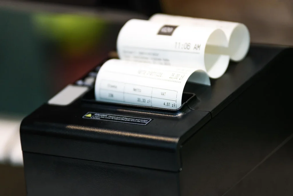 cash register receipt A cash register printer printing a receipt