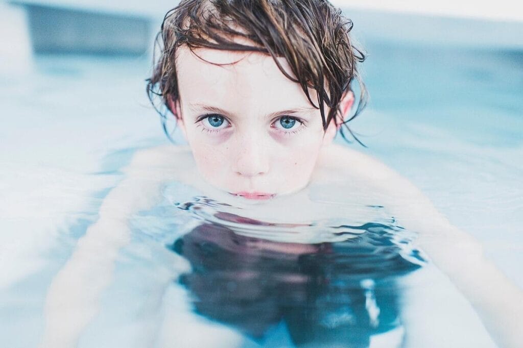 child swimming Racial disparities in drowning deaths. A boy in a swimming pool