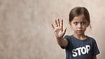 Little girl wearing a t-shirt that says stop, hold up a hand to say stop pro-israel groups critics of israel