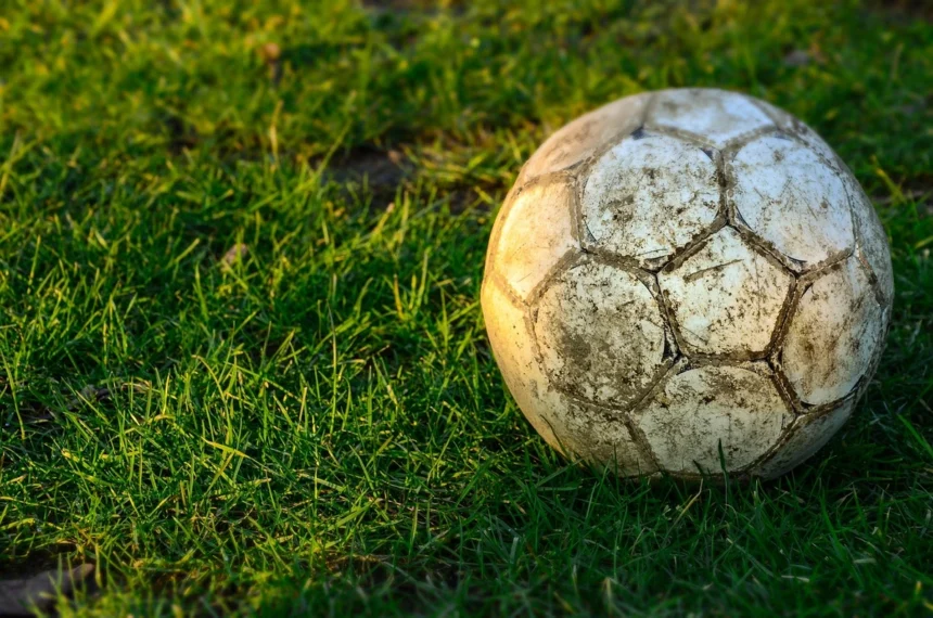 Fifa world cup disaster. A muddy soccer ball in the grass